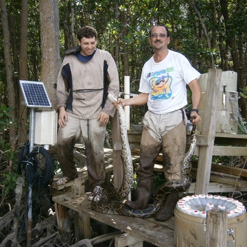 Valentin Nechita (left) and Rafael Travieso (right) with a Burmese python at SRS-6