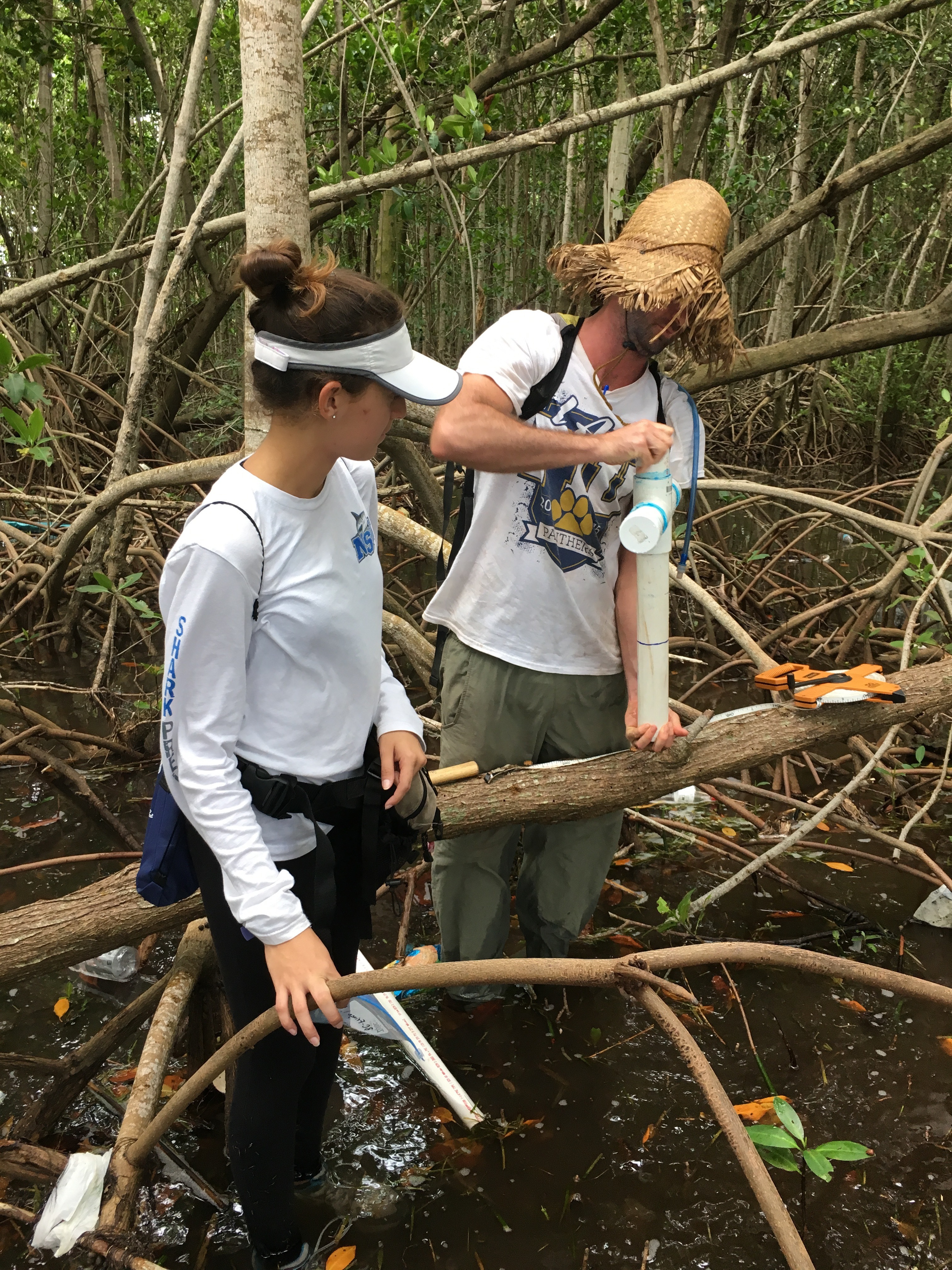 Sean Charles (FIU Ph.D. student) and Venus Garcia (FIU QBIC Undergraduate) collecting a soil core in Biscayne National Park.