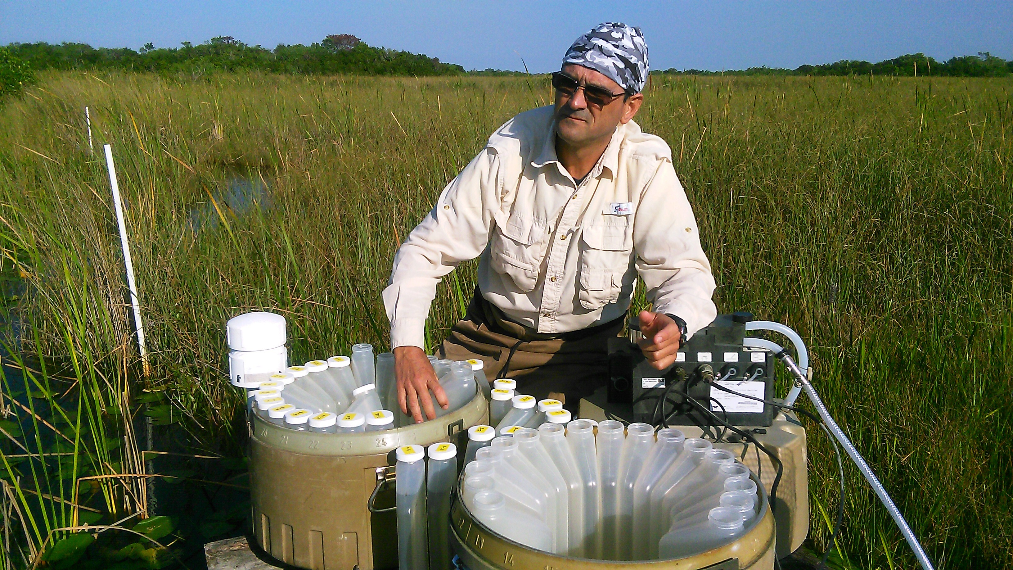 Rafael Traveiso collecting water samples from the autosampler at SRS-3, Shark River Slough